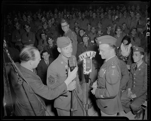 Two servicemen being interviewed at boxing match