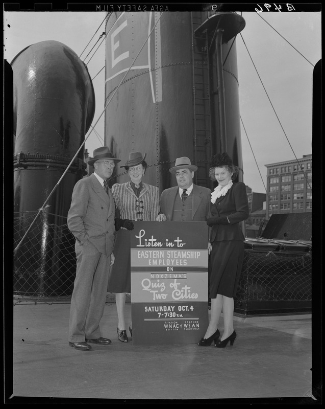 Eastern Steamship employees standing behind sign promoting Quiz of Two Cities