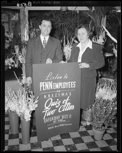 Penn employees behind sign promoting Quiz of Two Cities