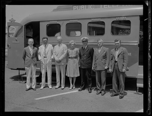 A group of people in front of a public telephone bus from the New Hampshire Telephone Company at the Portsmouth Navy Yard