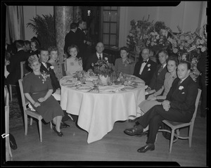 A group of people around a table at Copley dinner party