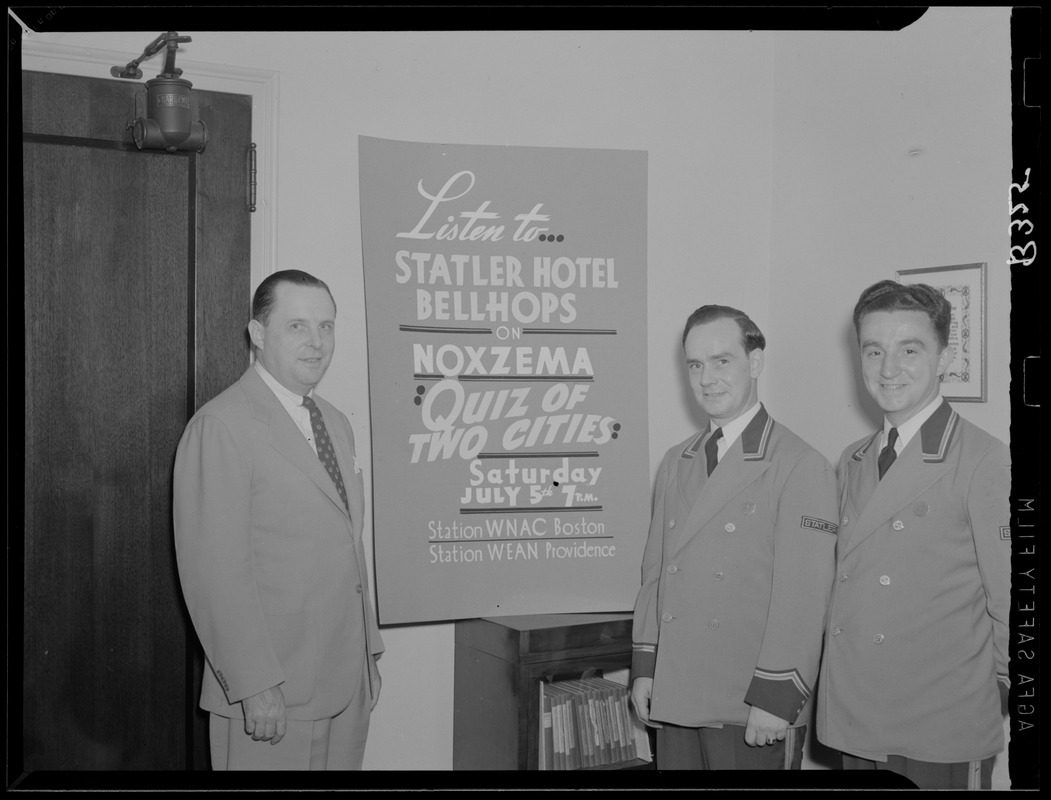 Bellhops with a sign promoting Quiz of Two Cities