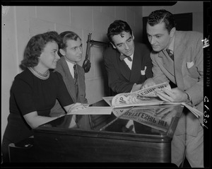 Announcers leaning over table