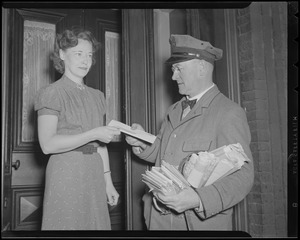 Postal service employee delivering a letter to a woman