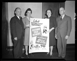 Four people stand with sign promoting Quiz of Two Cities