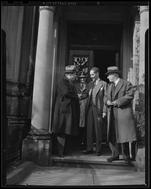 Four men exiting a building