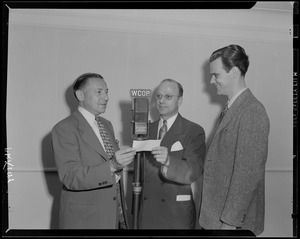 Mr. King and two men at the microphone