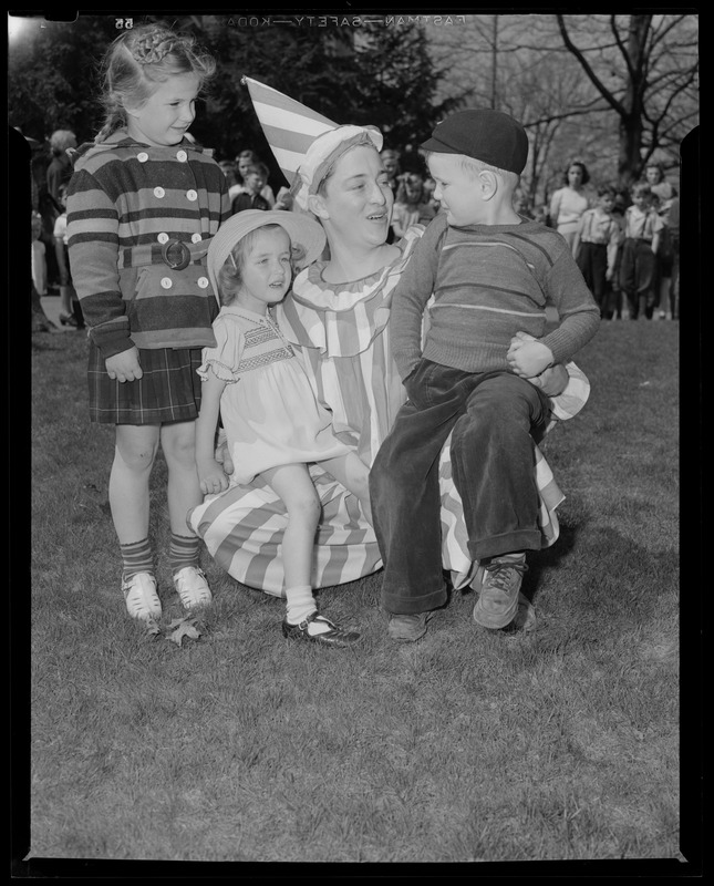 Woman in mime clown costume with children