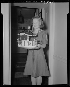 Portrait of girl scout with carousel cake