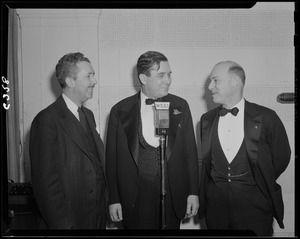 Three men at a microphone