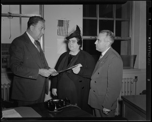 Two men and a woman holding paper