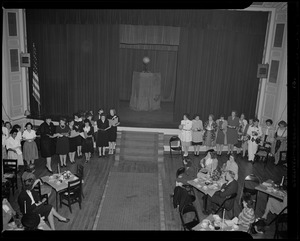 Group of women lined up in front of stage