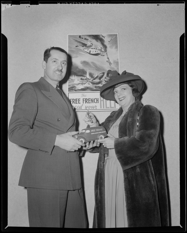 Unidentified man and woman posing with toy Free France truck