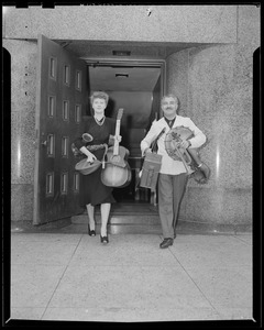 Arthur Fiedler and Harter walking with musical instruments