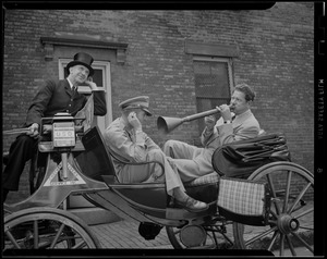 Three men in drawn carriage