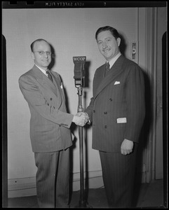 Jack Stevens and Mr. Armstrong shaking hands at the microphone