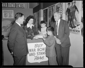 Boy buying stamps at the Suffolk Federal Savings War Bond Center