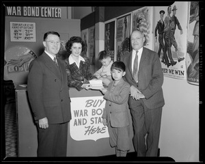 Boy buying stamps at the Suffolk Federal Savings War Bond Center
