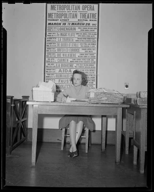 Woman sitting at desk in the Boston Opera Association office