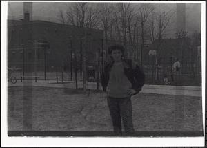 Teenage girl, possibly Bettie, standing in a park
