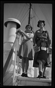 Narcisse, Narcissa, and Stephanie standing on board a ship