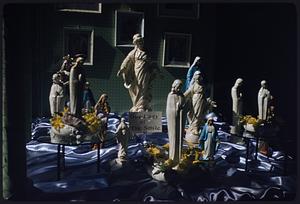 Display of religious figurines including Our Lady of the Smile, Boston