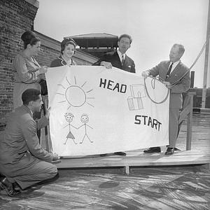 Mayor Edward Harrington holding PACE Headstart flag, New Bedford