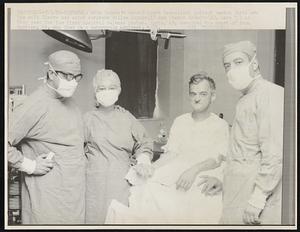 With Canada's second heart transplant patient Gaetan Paris are his wife Claire and chief surgeons Gilles Lepage (L) and Pierre Grondin (R), here 7/1 as they pose for the first hospital release photos. Paris, 49, received the heart of Yvon Bastien, 23, who died in a motorcycle accident, 6/27.