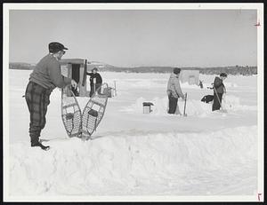 Fishing through the ice on lake Winnipesaukee - N.H.