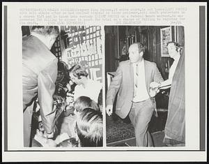 Gregory King Nelson, 19 white shirt, is cut loose (LEFT PHOTO) with bolt shears after he had chained himself to other anti-war, anti-draft protesters in a church 10/1 and is taken into custody (RIGHT PHOTO) on a Federal bench warrant. He was arrested for failing to appear in court for trial on a charge of failing to register for the draft.