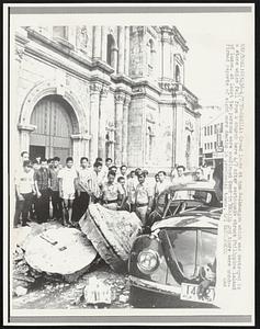 Crowd looks at new Volkswagon which was destroyed by a stone which fell from a church here 4/7 after earthquake struck Philippine island of Luzon. At least two persons were confirmed dead in Manila and there were confirmed reports of eight more deaths in provincial towns.\