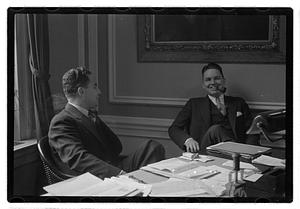 Two men seated at a desk