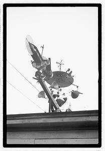 An elaborate device on roof, possibly a weather vane