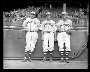 3 Braves lean aginst rail