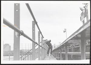 Boy posing next to the bleachers