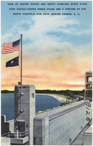 View of United States and South Carolina State flags atop Santee-Cooper Power House and a portion of the North Pinopolis Dam near Moncks Corner, S. C.