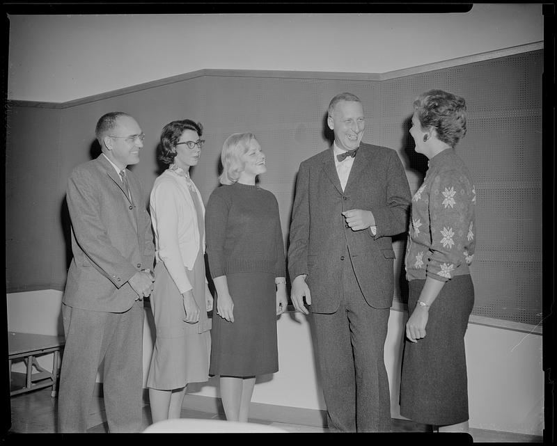 Group talking to man with bow tie