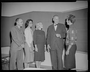 Group talking to man with bow tie