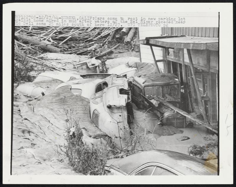 Cars come to rest in new parking lot against home mired in mud after waters of the Eel River receded near Rio Dell some 25 miles south of here 12/27.