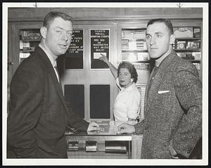 Big Event, to these two members of Washington Senators, anyway, is pointed out by Inez of the Kenmore at lobby news counter. The Senators are Outfielder Karl Olson, who played with Red Sox last year, and Infielder Lyle Luttrell.