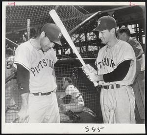 Pirate Skulls - Catcher Joe Garagiola (left) flinches as teammate Johnny O'Brien goes to bat to test new plastic caps the Pirates are using this season.