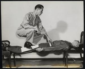 GI Shennanigans--Pvt. George Bent, an otherwise average GI becomes a superman and is able to support his hypnotist, Pvt. Lee Burchell of Randolph, while suspended between two chairs. Son of Mr. and Mrs. Elmer Burchell of 35 Orchard street, hypnotist Burchell is stationed at Lowry Field, Col. He believes hypnosis will be valuable as a form of treatment for mental casualties in the war. A professional magician in civilian life, Burchell used the stage of Lee Noble.