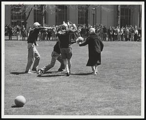 In This Photo evasive action is countered by placement of a wicket - and placement of a mallet nearly on someone's head. First all-MIT game of "fierce croquet" was played in the Great Court. When confused spectators asked who won, the answer was "Croquet".