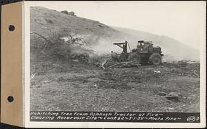 Contract No. 62, Clearing Lower Middle and East Branches, Quabbin Reservoir, Ware, New Salem, Petersham and Hardwick, unhitching tree from Oshkosh tractor at fire, Enfield, Mass., Mar. 1, 1939