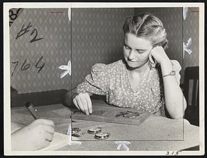 A Visit To a Human Engineering Laboratory. This young lady is doing the finger dexterity test at the Human Engineering Laboratory at Stevens Institute of Technology. The speed with which she picks up the pins, three at a time, and places them in the holes, is an index to how well she can do delicate manipulative work with her fingers. Finger dexterity is useful in such activities as handicraft, factory assembly jobs, etc.