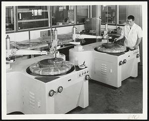 Triple Motion Polishing machines, designed and built by Diffraction Limited, are used to polish certain lenses. Here optician William Masionis applies a special liquid used in the process.