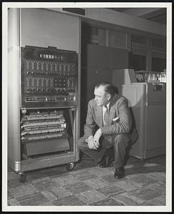 Intricate Mechanism of 650 electronic data processing machine" is examined by Associate Controller Harold F. Hatch.
