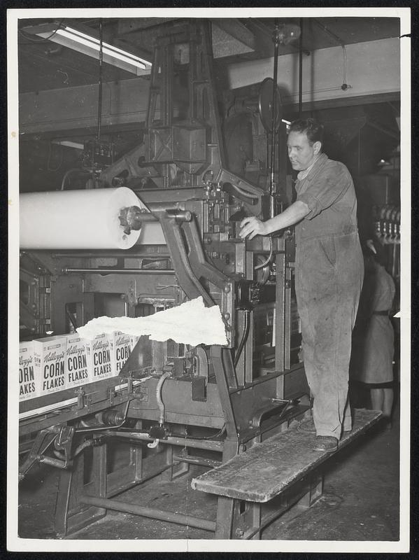 Marshall Aid lining machine at Kellog factory in Stretford is operated by W. H. Hammett of Flixton. This machine, made by the Pneumatic Scale Corporation, Limited, of Norfolk Downs, makes a bag from the great roll of waxed paper and fits it into each carton.