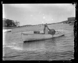 Fishermen with lobster trap on boat "C2860"