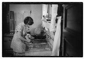 Woman doing laundry at a sink